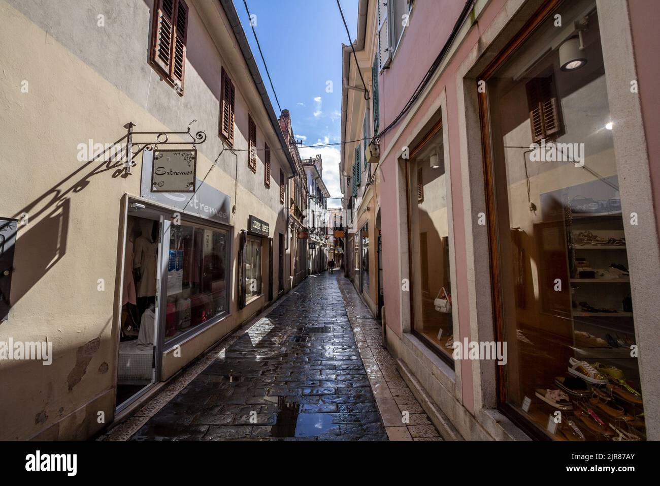 Picture of a narrow medieval street of the historical center of Koper, Slovenia. Koper, or Capodistria, is the fifth largest city in Slovenia. Located Stock Photo