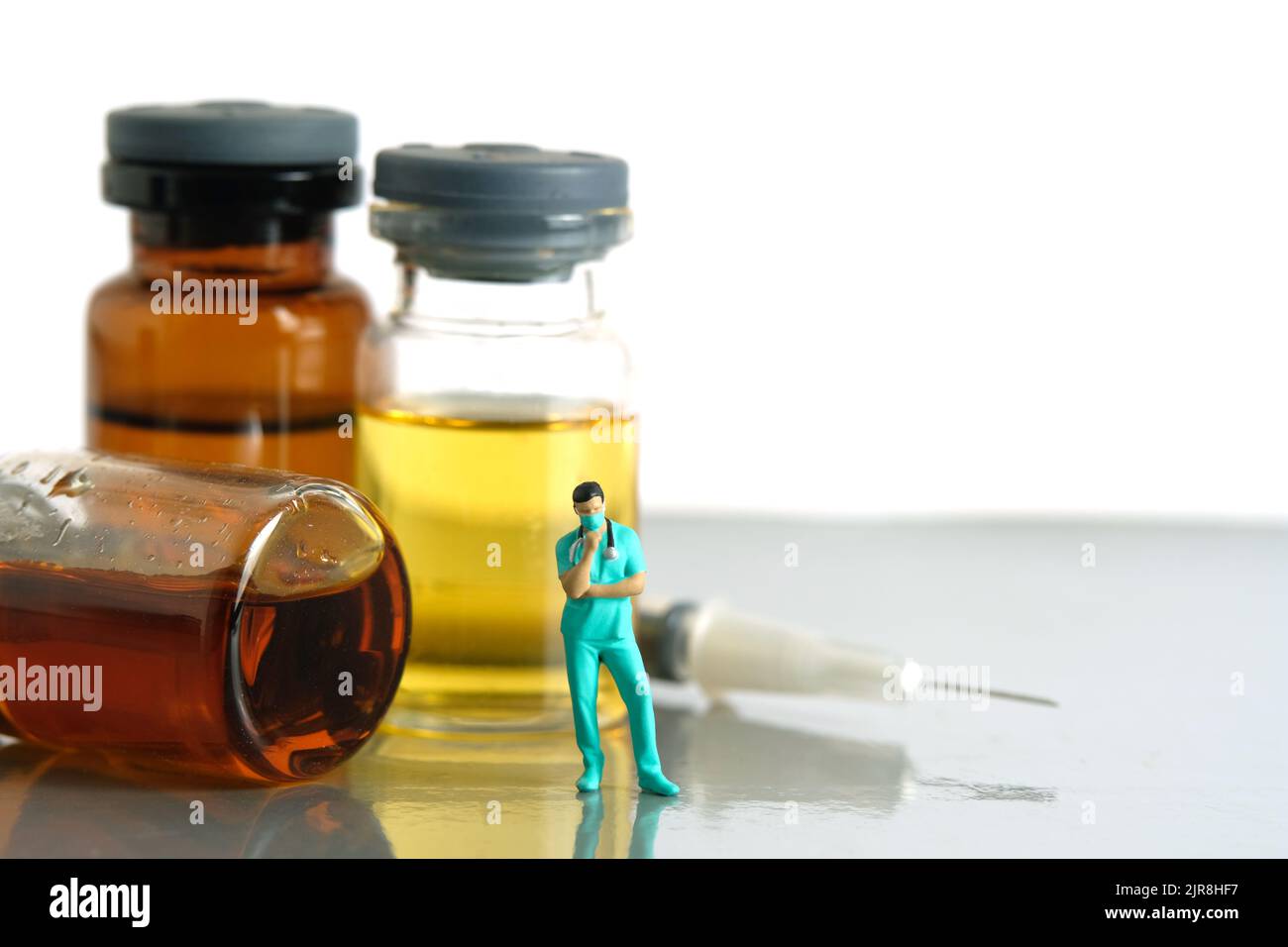 Miniature people toy figure photography. Urine test concept. A nurse standing in front of ampoule bottle and syringe. Image photo Stock Photo