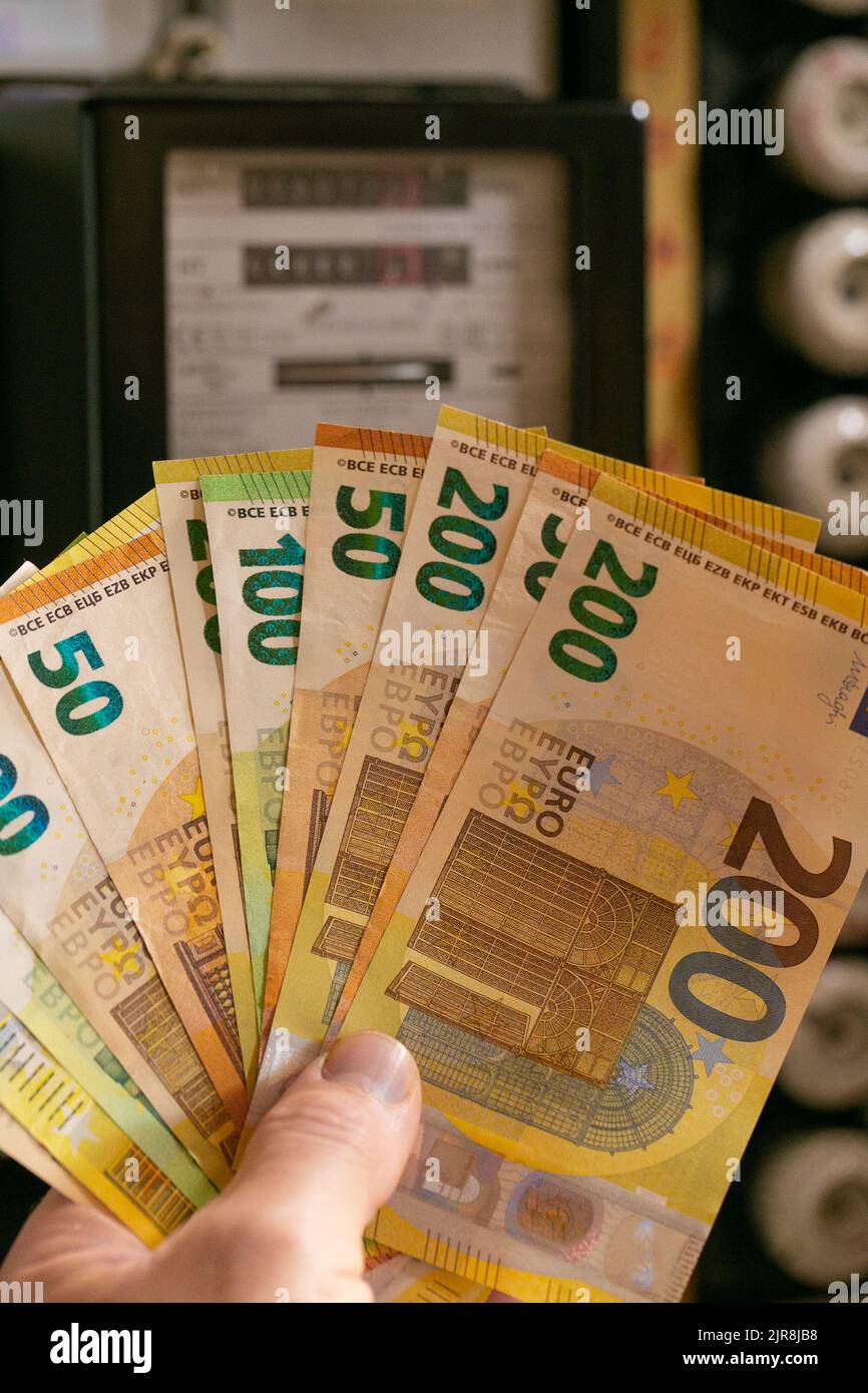Electricity cost in European countries.Hand holding euro bills on ...