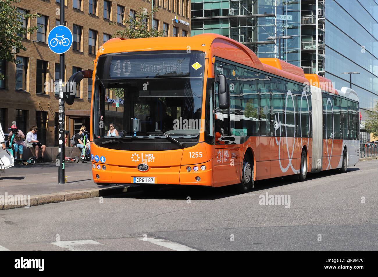 Helsinki, Finland - August 20, 2022: Orange electric articulated city bus on line 40 at the Central railroad station. Stock Photo