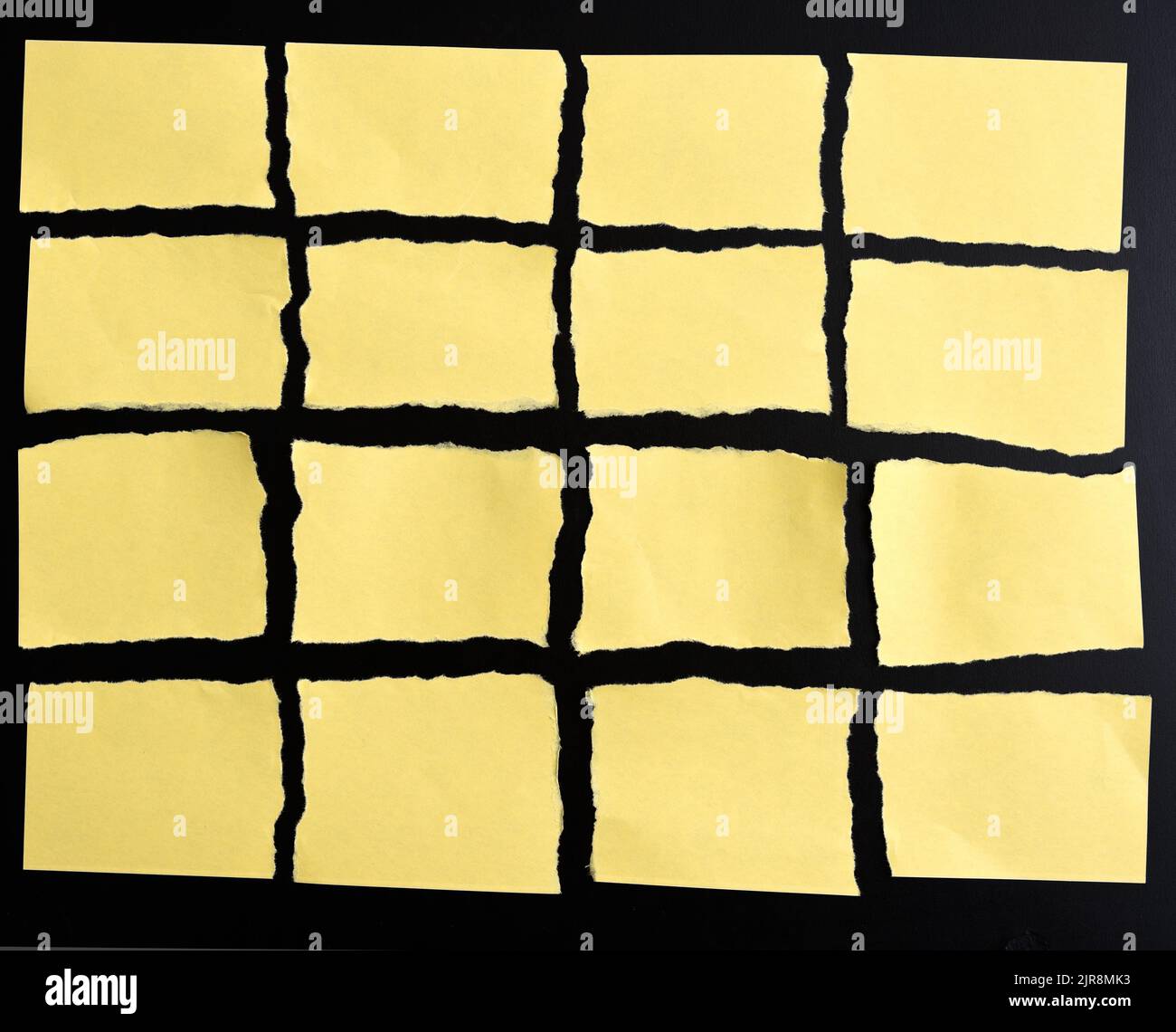Torn yellow paper on black background Stock Photo