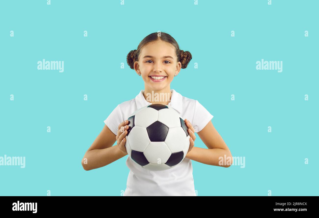Portrait of smiling girl with football ball Stock Photo
