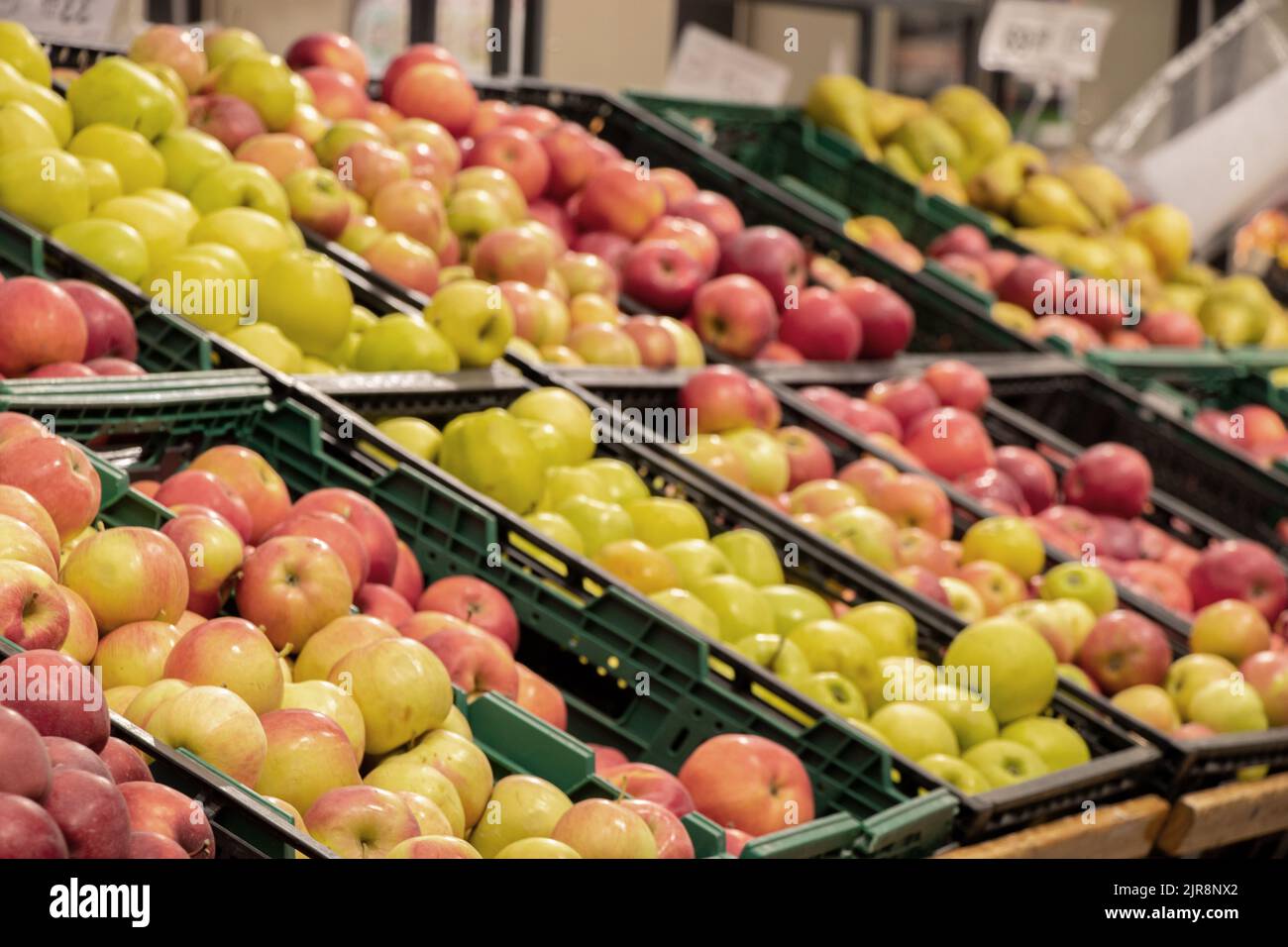 apples in a supermarket on showcases in boxes, fruits in a store for