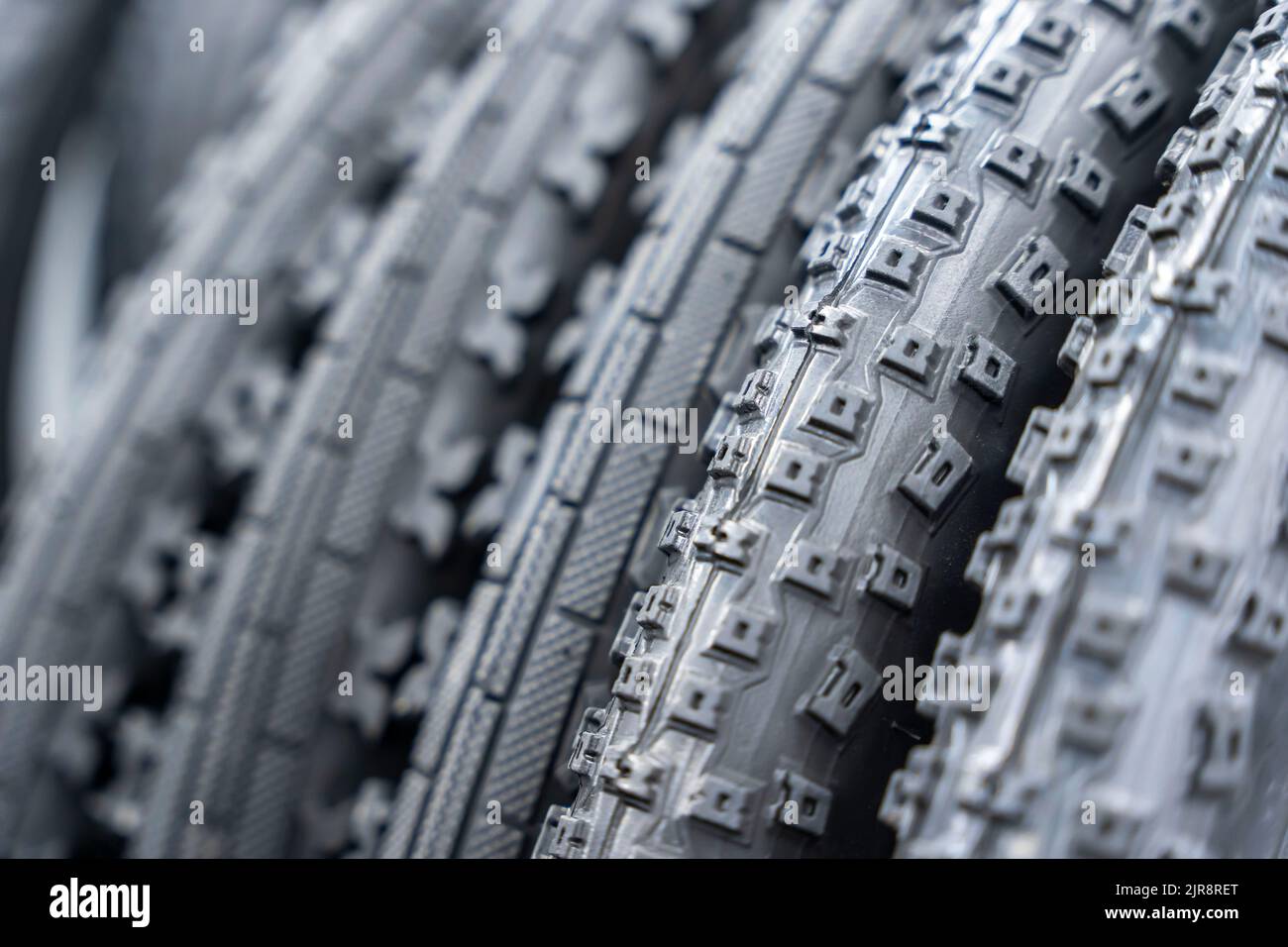 new bicycle tires in the storage. stack of black bike tires Stock Photo