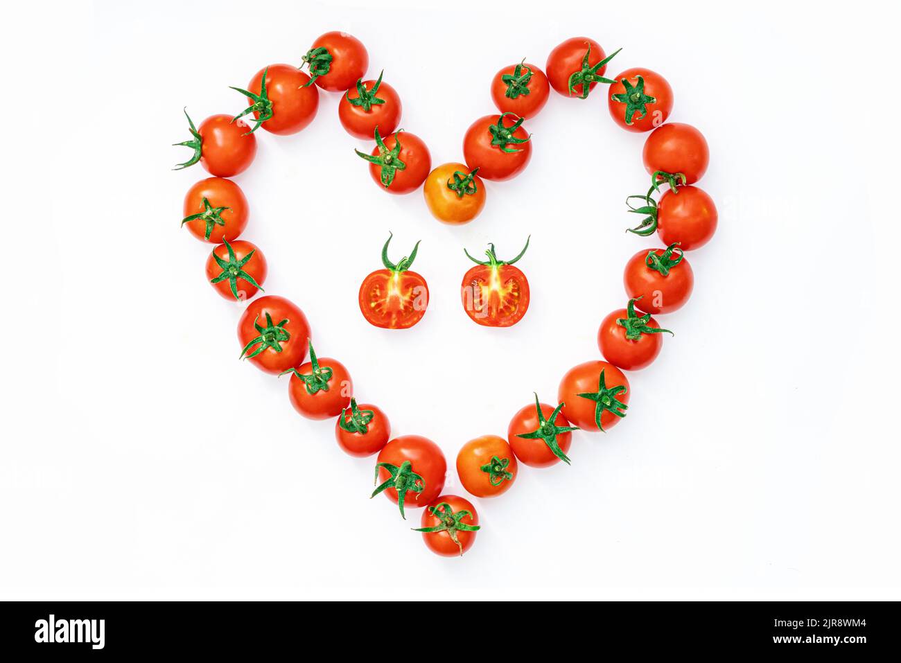 Cherry tomatoes laid out in the shape of a heart. I love vegetables and