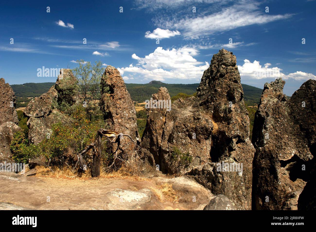 On a sunny day this jumble of lava rocks is quite attractive, but in mist they give Hanging Rock the air of mystery used by Joan Lindsay in her book. Stock Photo