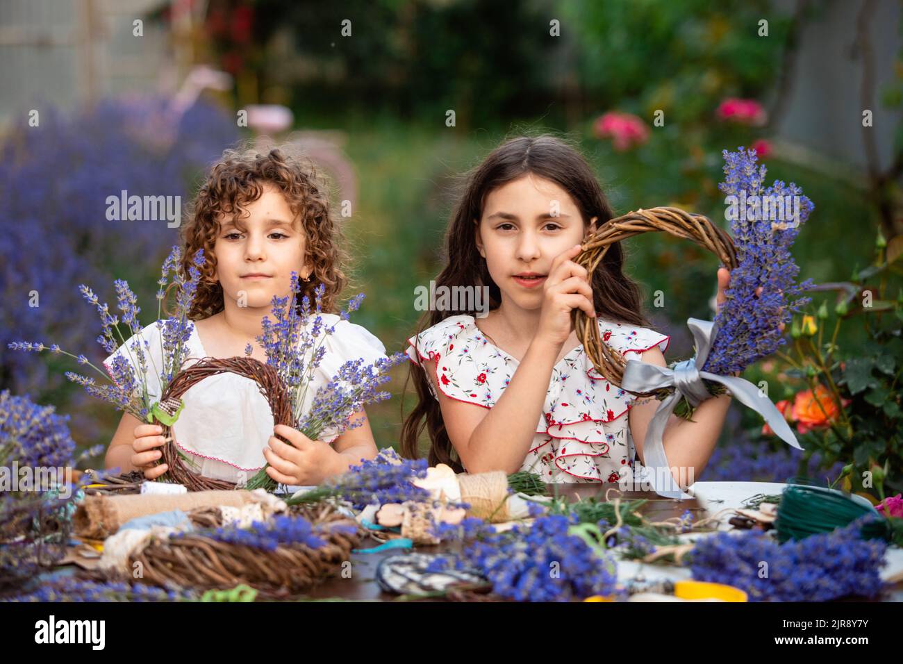 Girls make homemade lavender wreaths as a decor for home or present Stock Photo