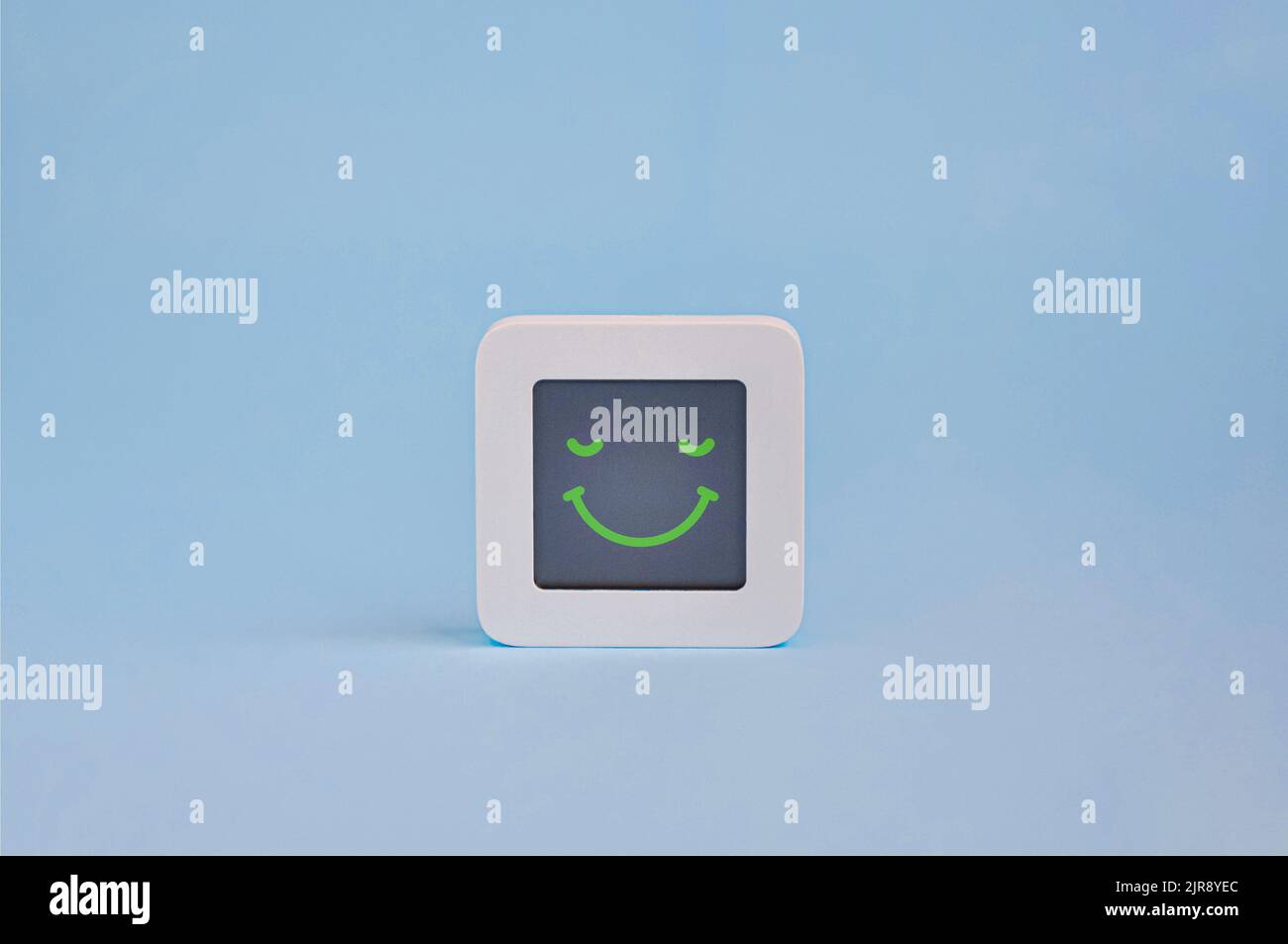 Happy emotion concept, symbol of smiley emoticon on lcd display isolated on colored background, Customer Experience Concept Stock Photo