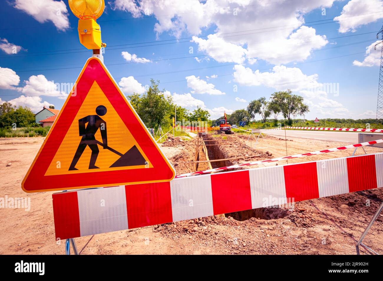 Sign with boundary and blink light signal are symbols of caution at