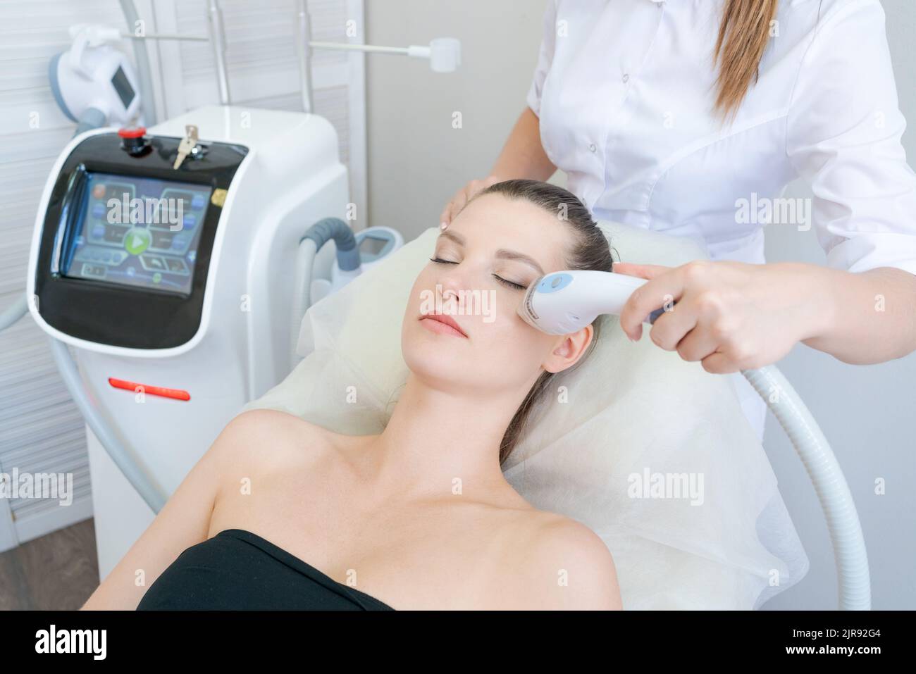 woman in beauty clinic receives nonsurgical face lift. SMAS