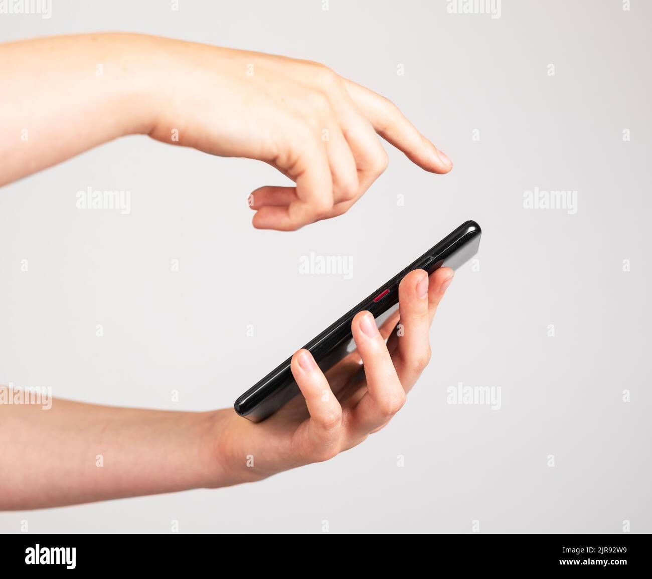 Woman hand closeup swiping phone screen. Female scrolling social media, looking through photos, news. High quality photo Stock Photo