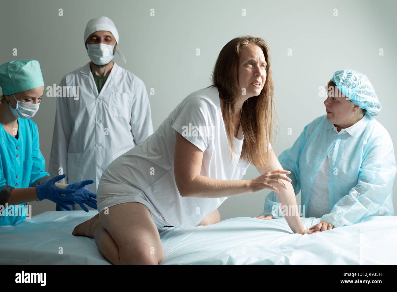 Child birth process, helping personal during natural labour Stock Photo