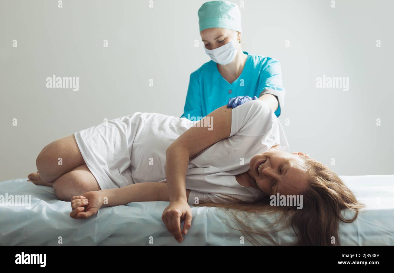 Doctor process epidural nerve block for pregnant woman during childbirth Stock Photo