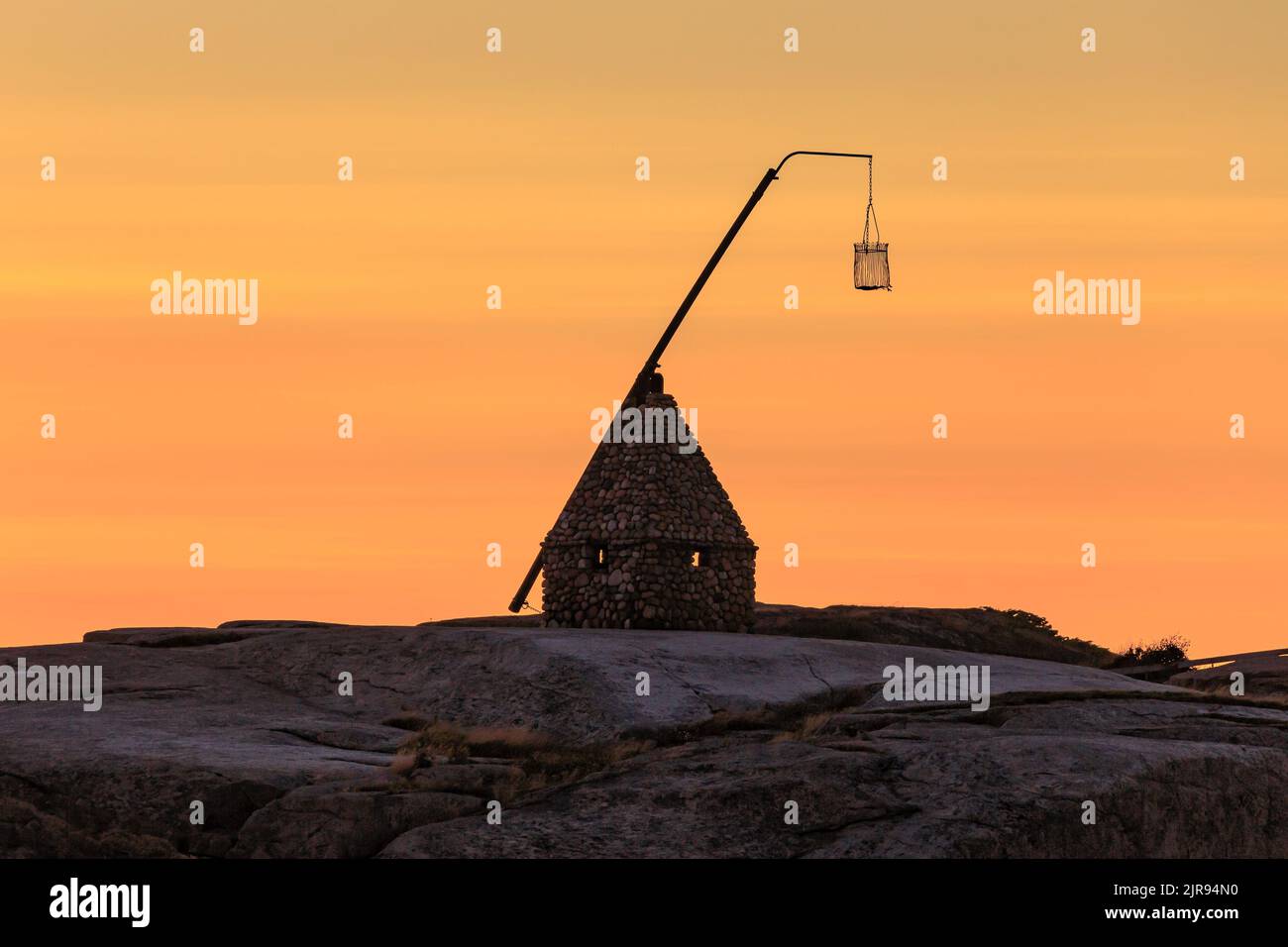 Sunset at the end of the world - Vippefyr ancient lighthouse at Verdens Ende in Norway Stock Photo