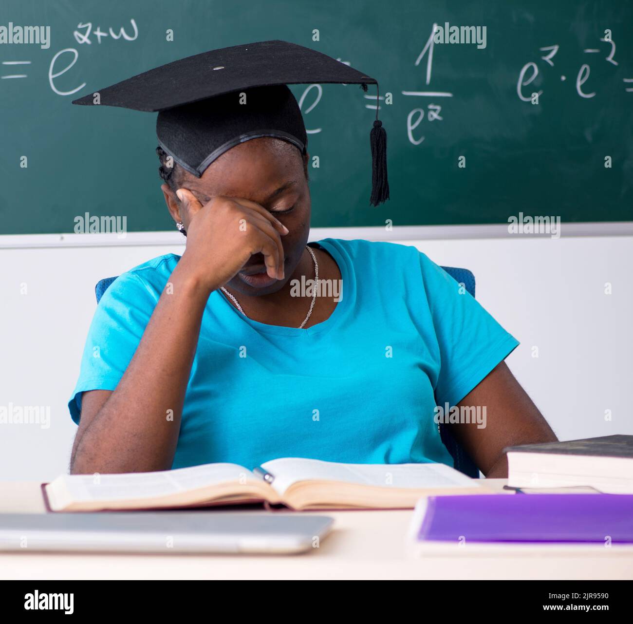 Black female student in front of chalkboard Stock Photo - Alamy
