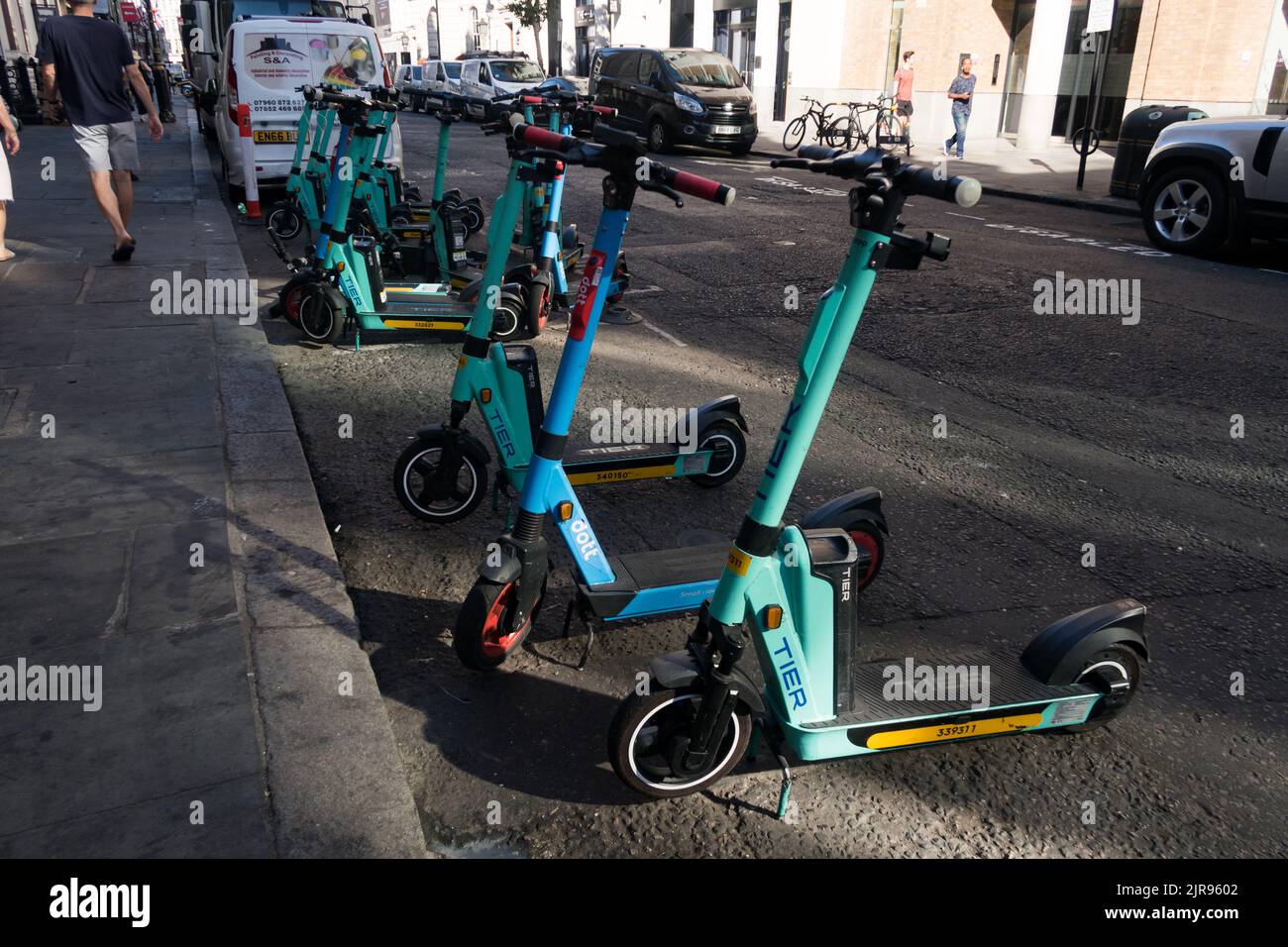 Tier e-scooter being scattered along  a road in London city center Stock Photo