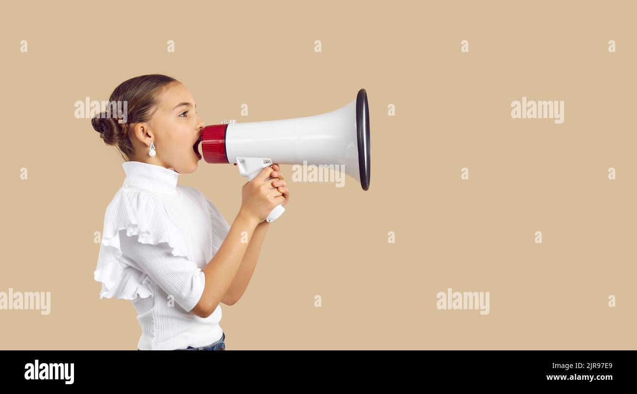 Little child with megaphone making announcement, sharing message or promoting event Stock Photo