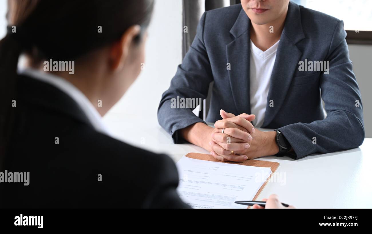 Male investor discussing investment plan with female lawyer or financial advisor Stock Photo