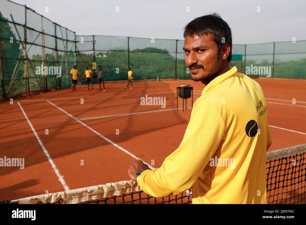 Coach and young boys at JayÕs Institute of Tennis in Trichy