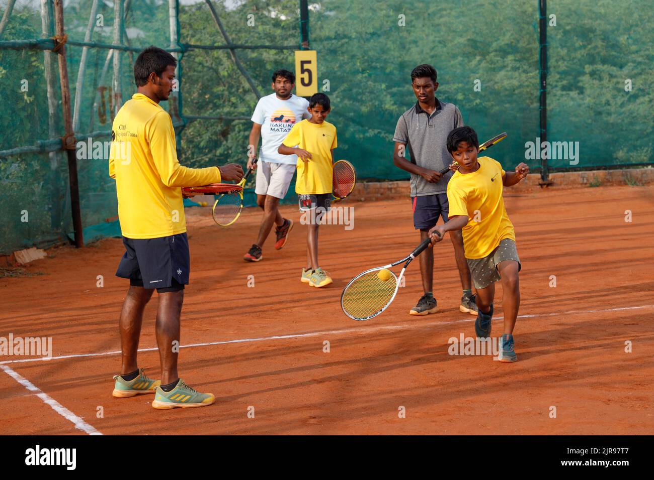 Coach and young boys at JayÕs Institute of Tennis in Trichy