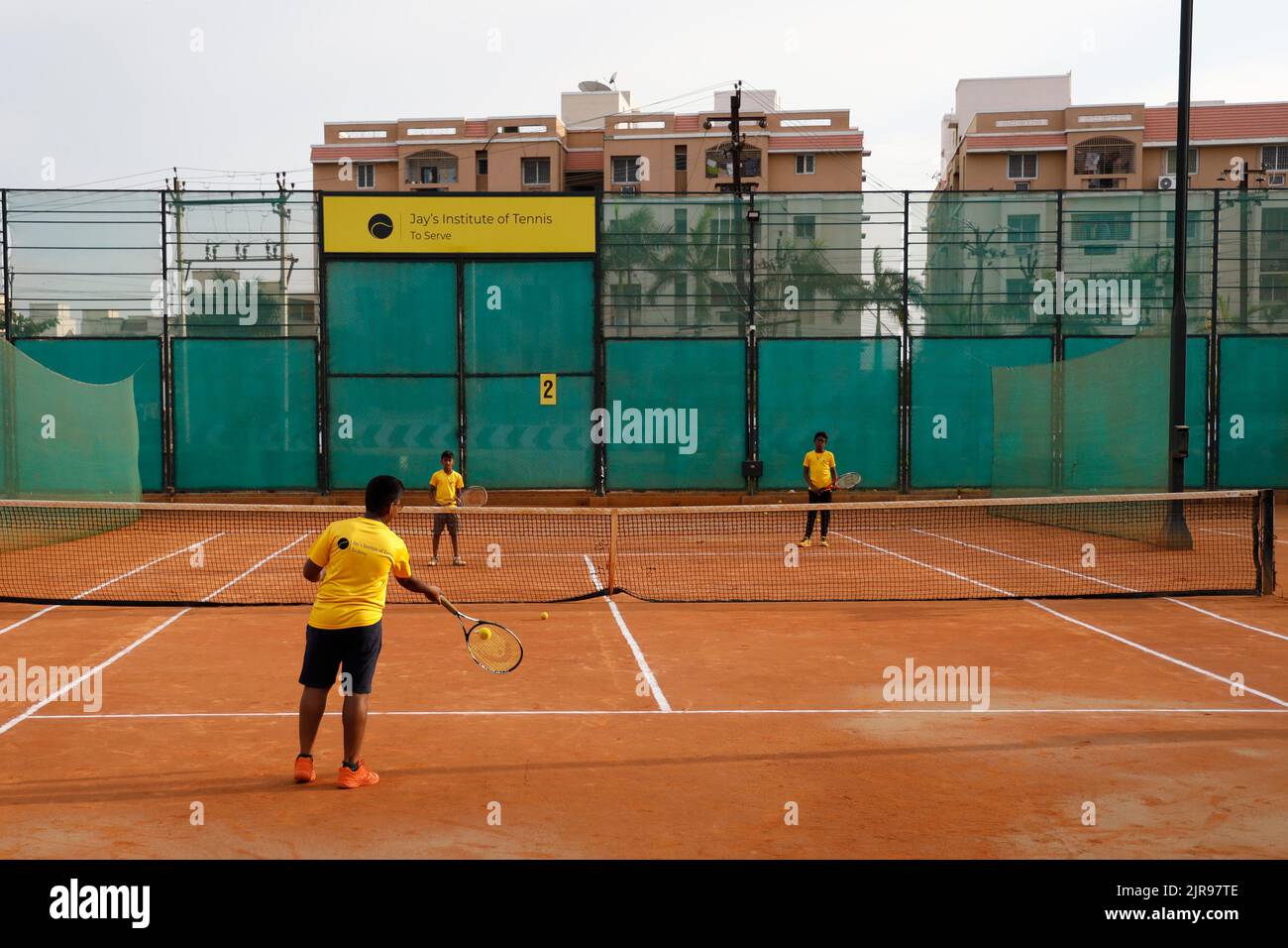 Coach and young boys at JayÕs Institute of Tennis in Trichy