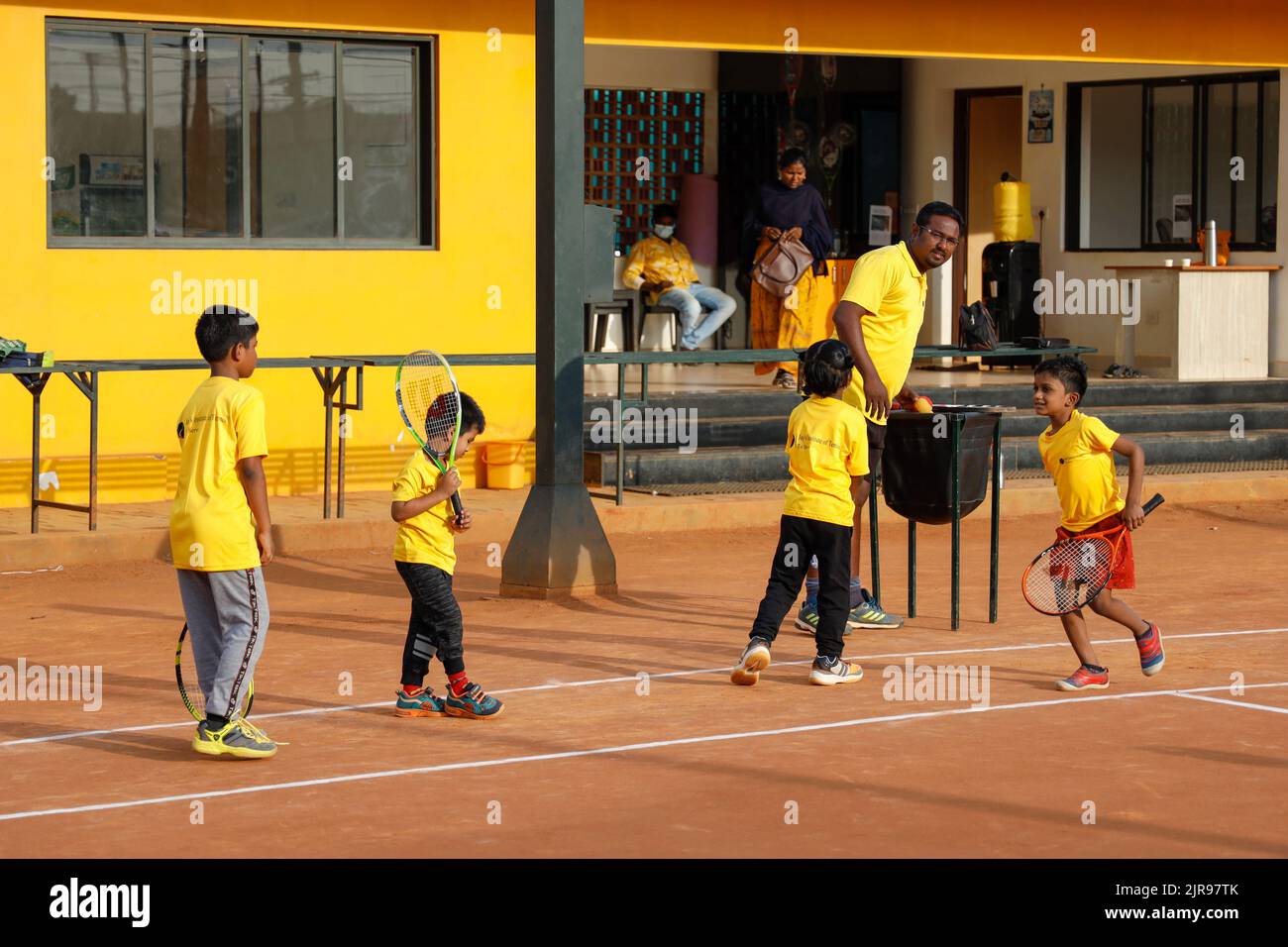 Coach and young children at JayÕs Institute of Tennis in Trichy