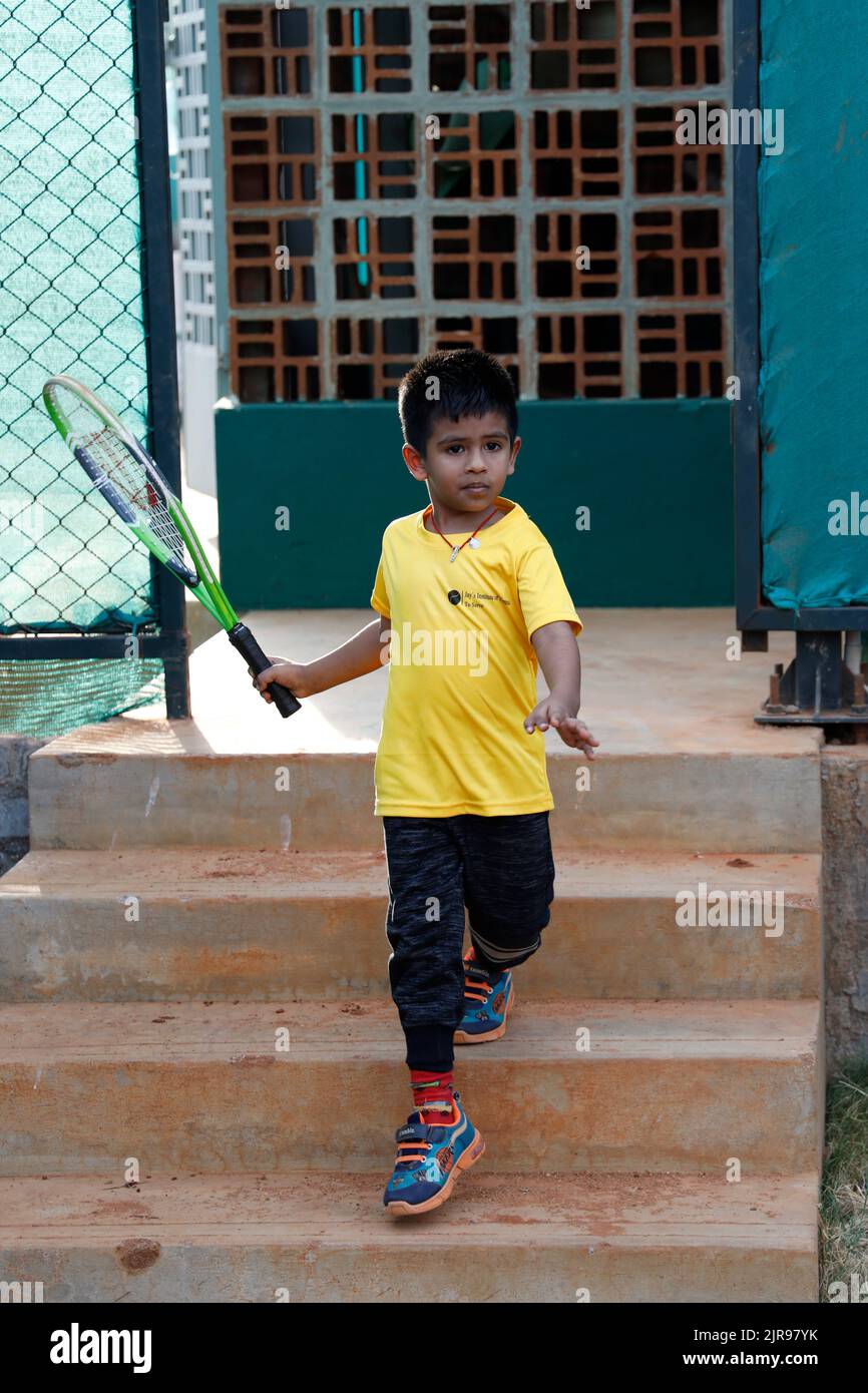 Young boy holding racket at JayÕs Institute of  Tennis  in Trichy/Tiruchirappalli, Tamil Nadu, India Stock Photo