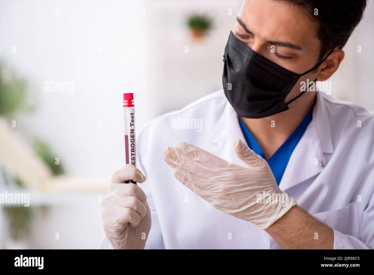 Young biochemist testing blood samples Stock Photo