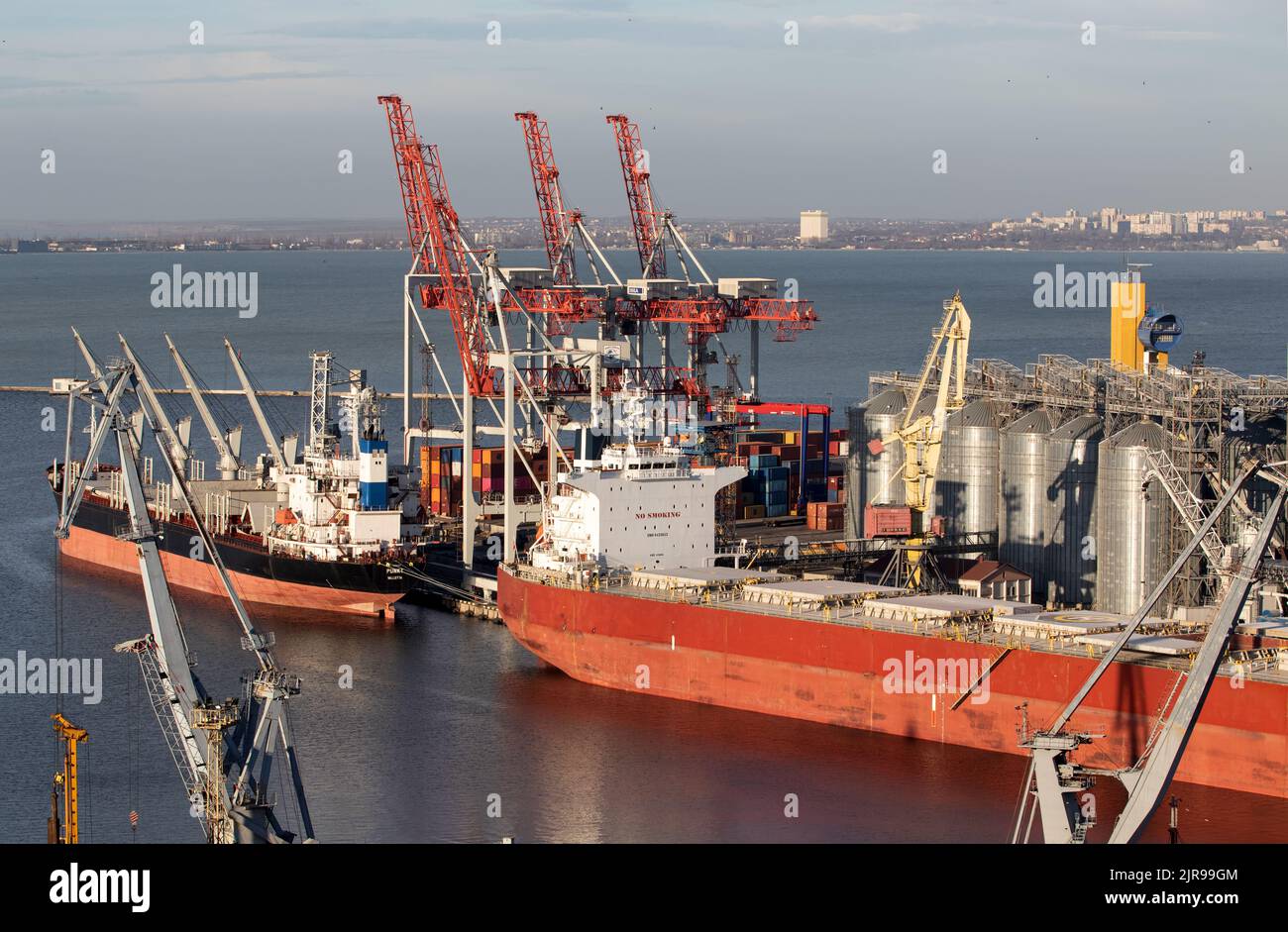 ODESSA, UKRAINE-NOVEMBER 27, 2021: Odessa commercial sea port in peacetime 4 months before start of war with Russia. Marine cranes, warehouses, tanker Stock Photo