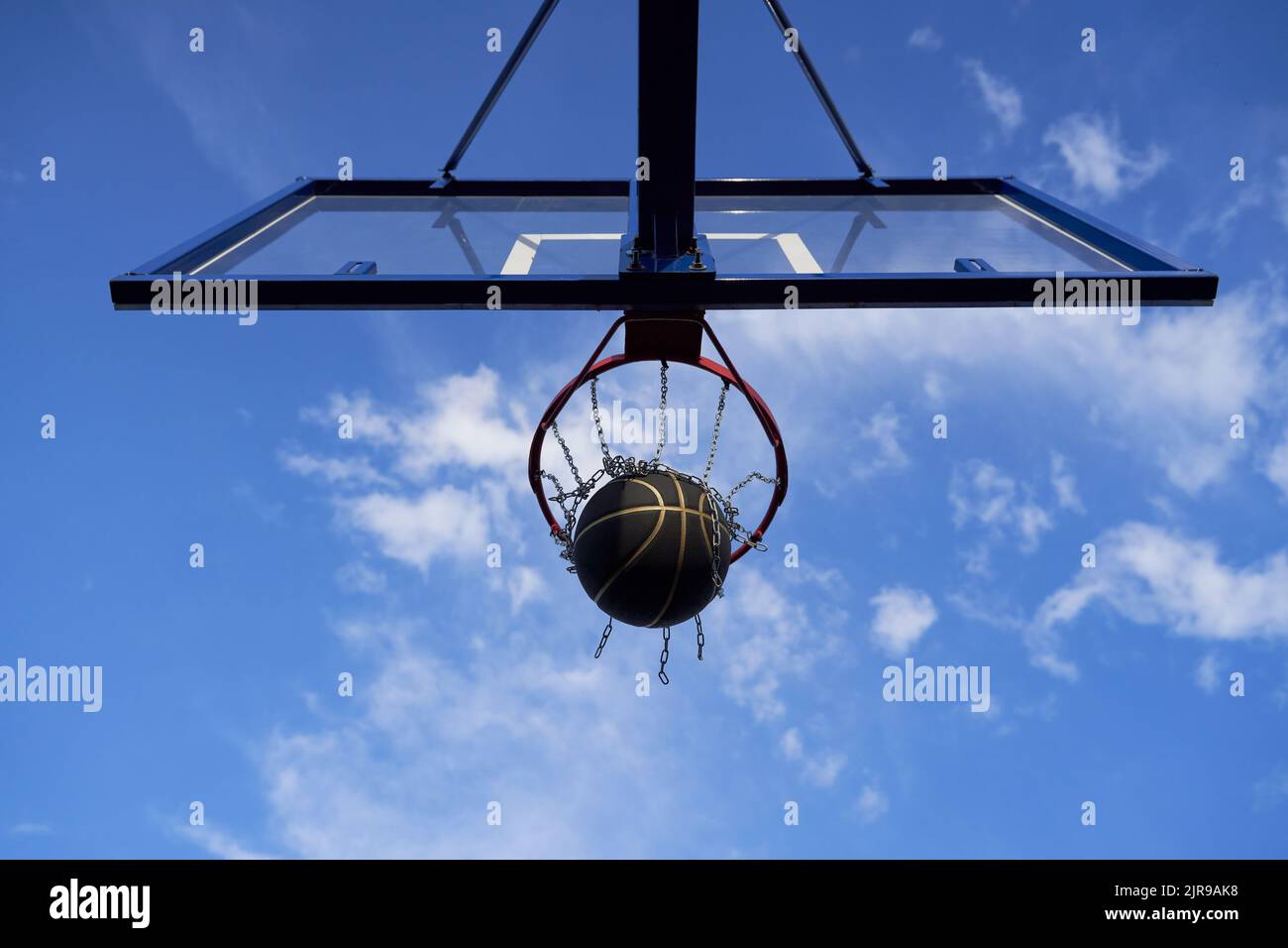 Street basketball ball falling into the hoop. Urban youth game. Concept