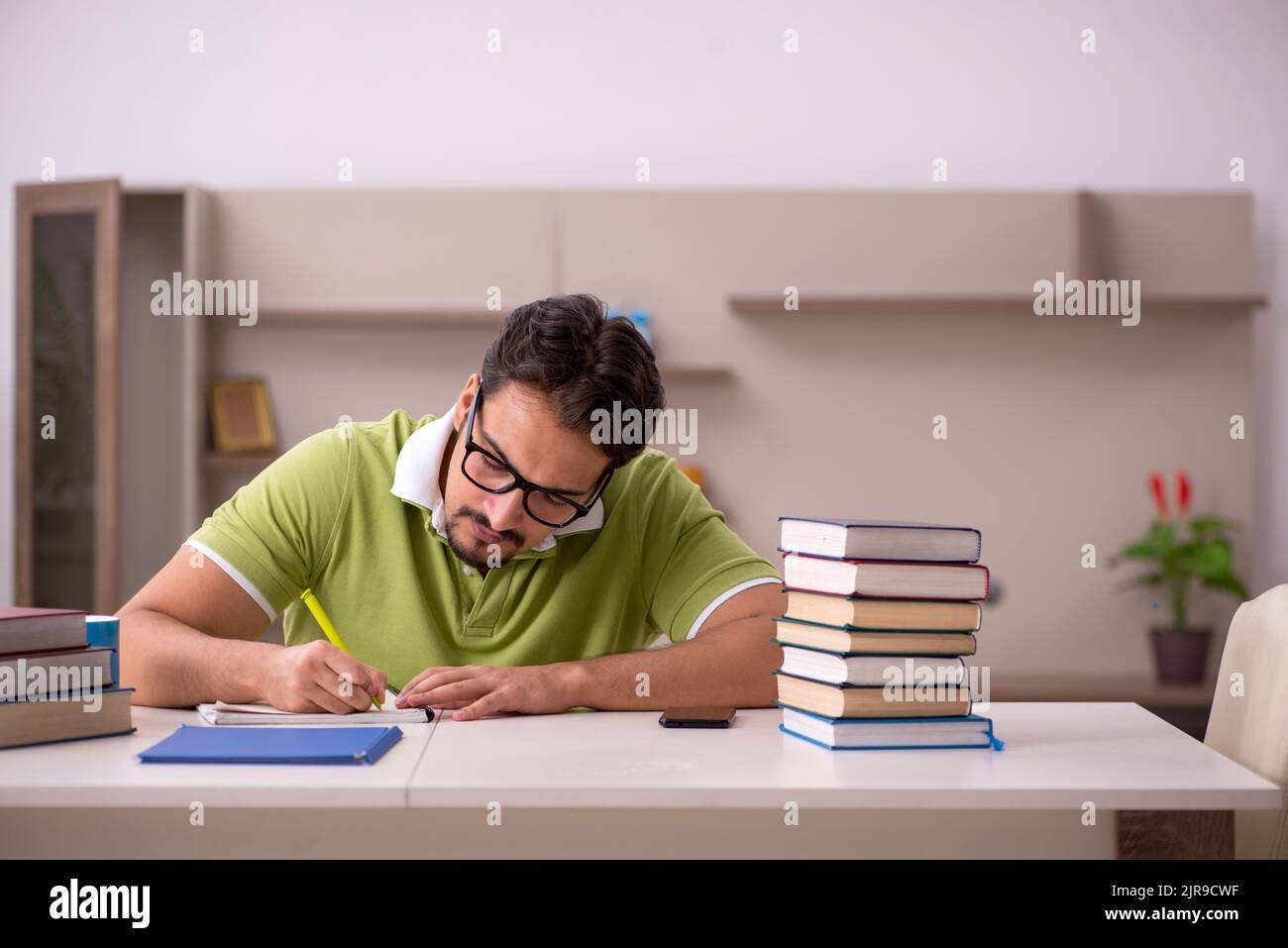 Young student studying at home Stock Photo - Alamy
