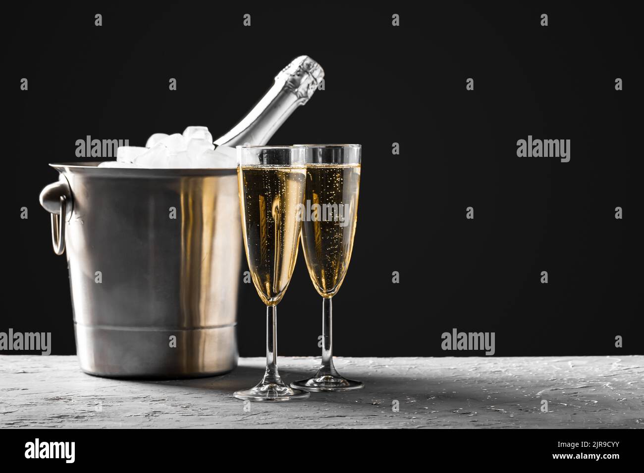 glasses of champagne with a champagne bottle in a bucket Stock Photo