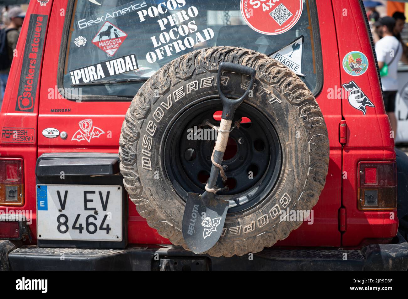 A rear view of a spare wheel and shovel of an old red Mitsubishi Montero Pajero SUV Stock Photo