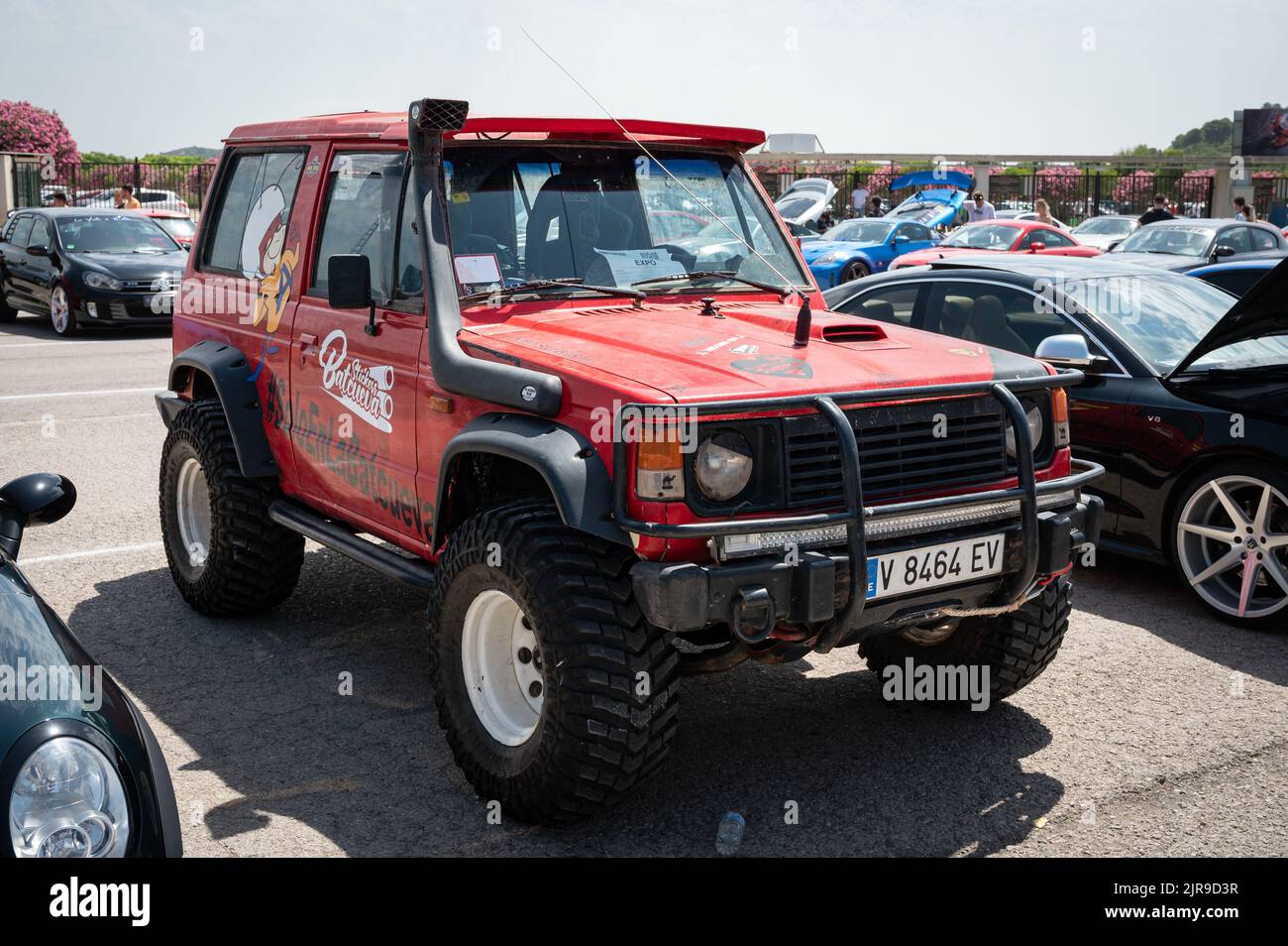 A front view of an old red all-terrain Mitsubishi Montero parked on the street Stock Photo