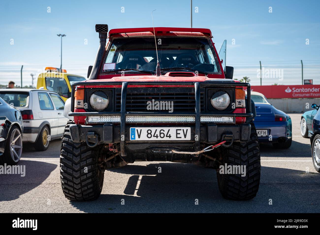 A front view of an old red all-terrain Mitsubishi Montero parked on the street Stock Photo