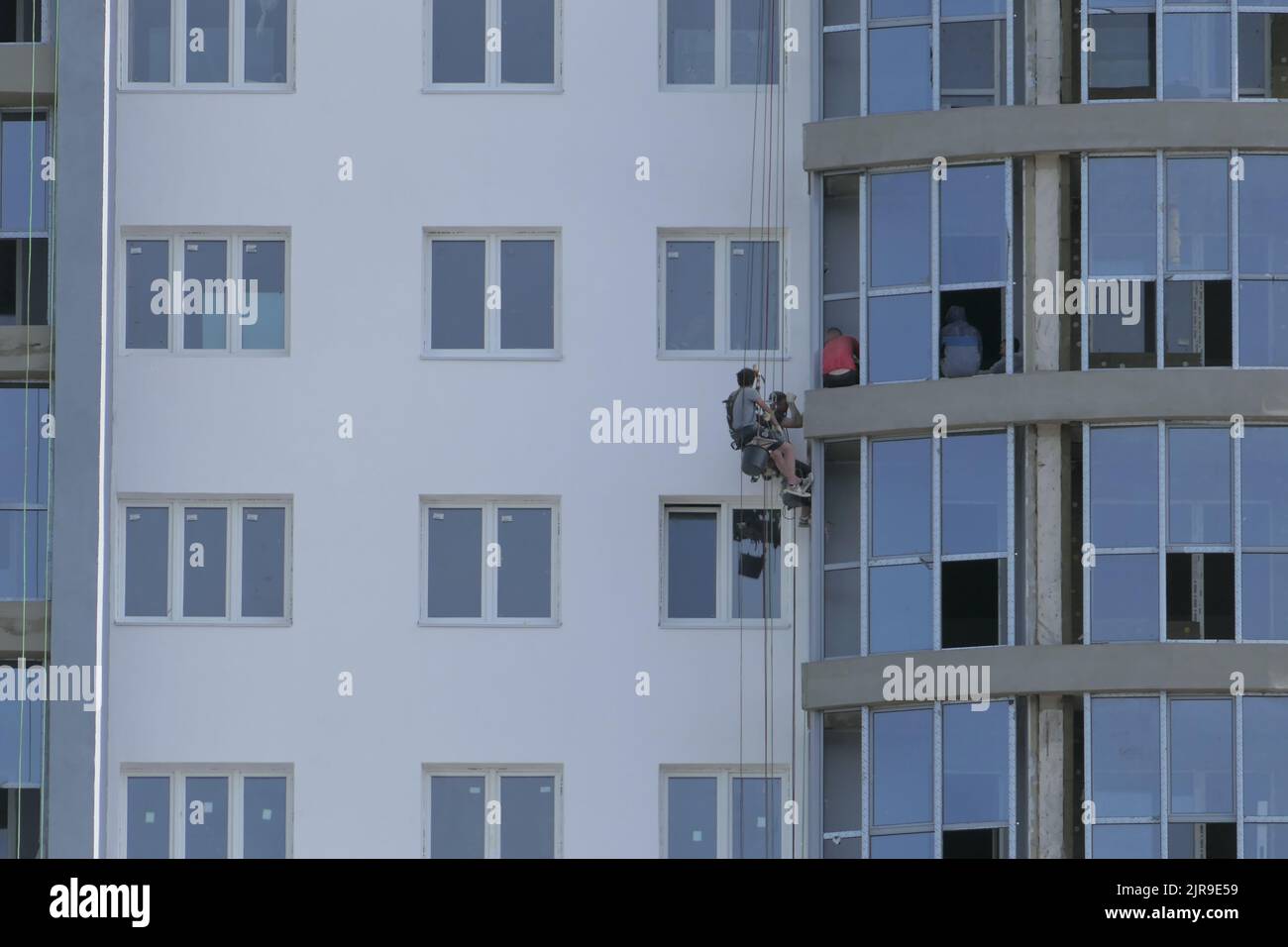Nizhny Novgorod, Russia, Verkhnevolzhskaya embankment, 08.20.2022. Industrial mountaineering. A male specialist, a climber, in special equipment and s Stock Photo