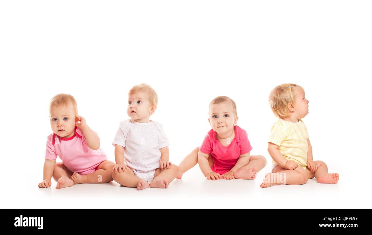 Group of witty babies sitting in different clothes, isolated on white background Stock Photo