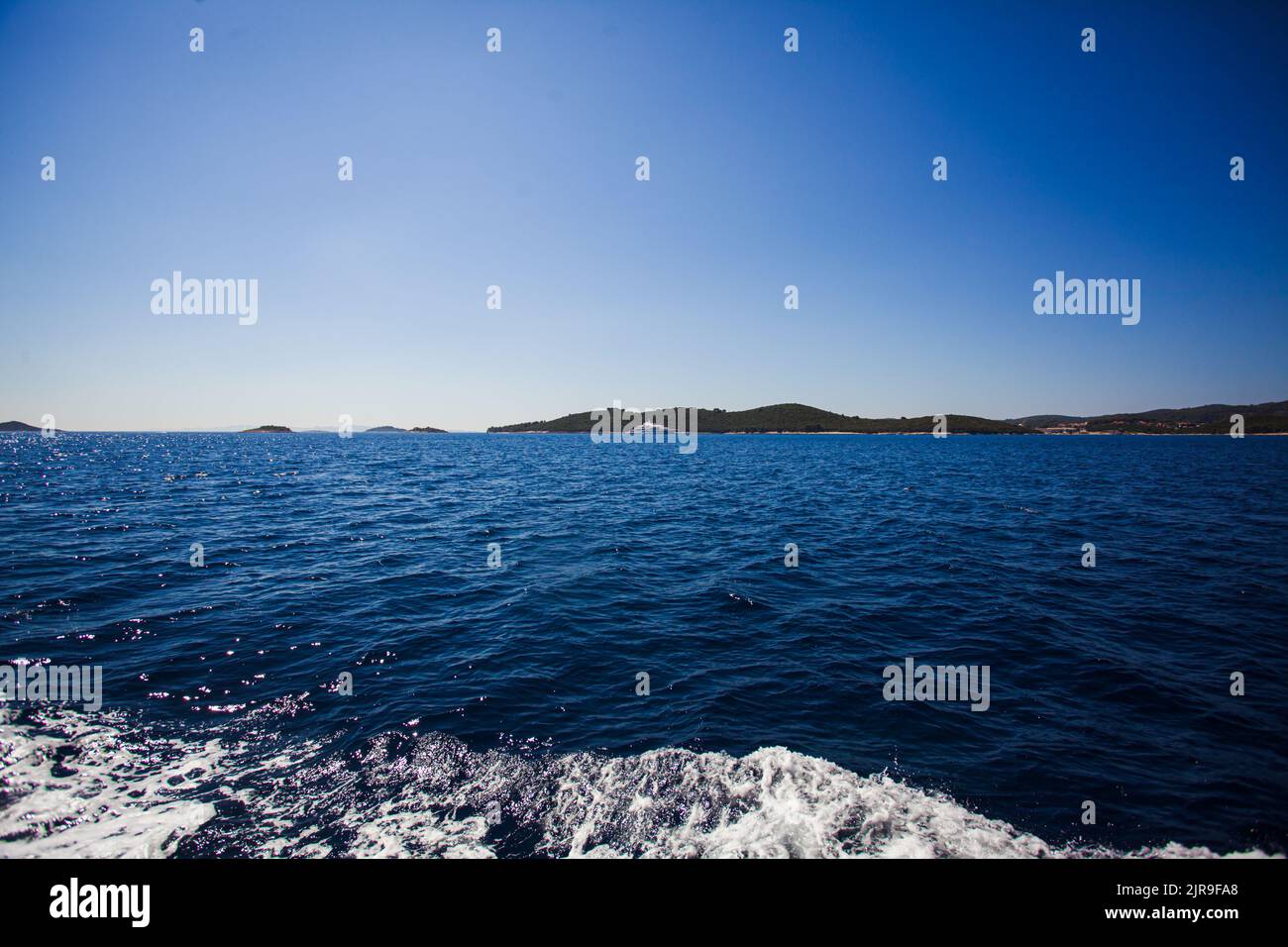 Beautiful minimalistic landscape, the surface of the sea under the blue sky. Natural abstract background and texture Stock Photo