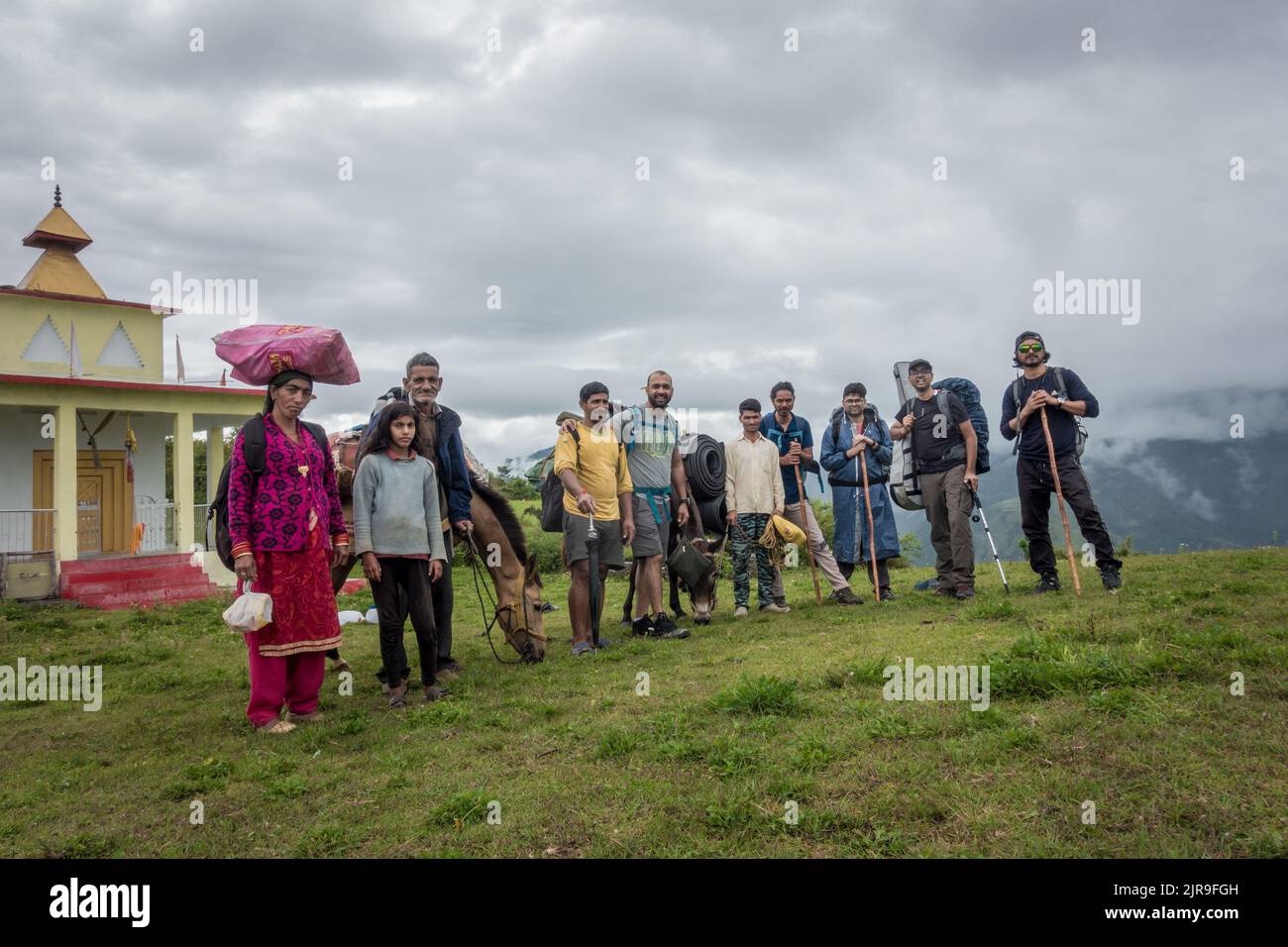 September 14th 2021 Uttarakhand INDIA. Hikers with backpacks and walking sticks on a Himalayan trek with local guides and porters and mules. Stock Photo