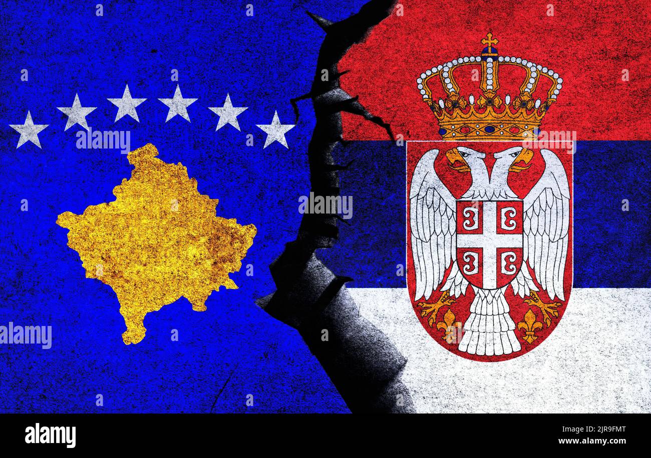 Serbia vs Kosovo concept flags on a wall with a crack. Kosovo and Serbia political conflict, war crisis, economy relationship, trade concept Stock Photo