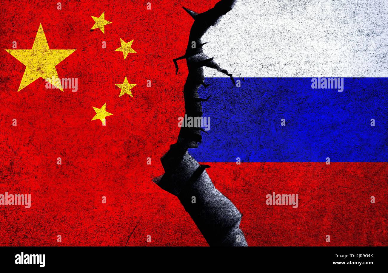 Russia vs China concept flags on a wall with a crack. China and Russia