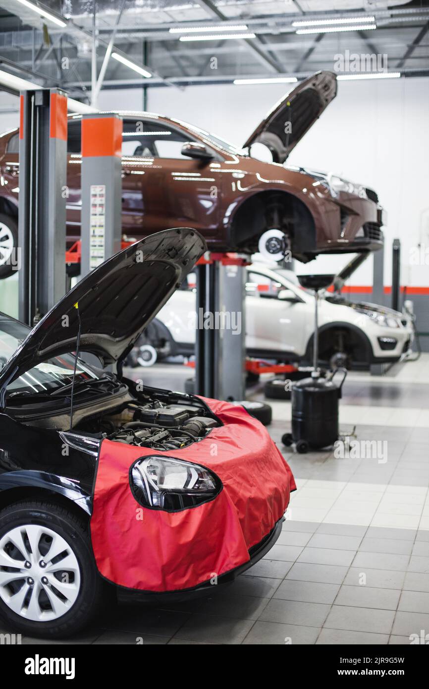 preparing a car for repair at a service, a car on a lift Stock Photo