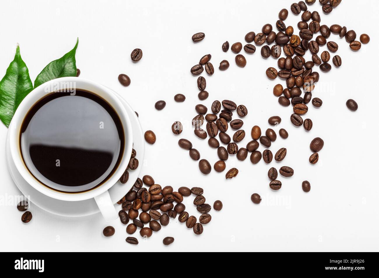 Coffee cup and beans on a white background Stock Photo - Alamy