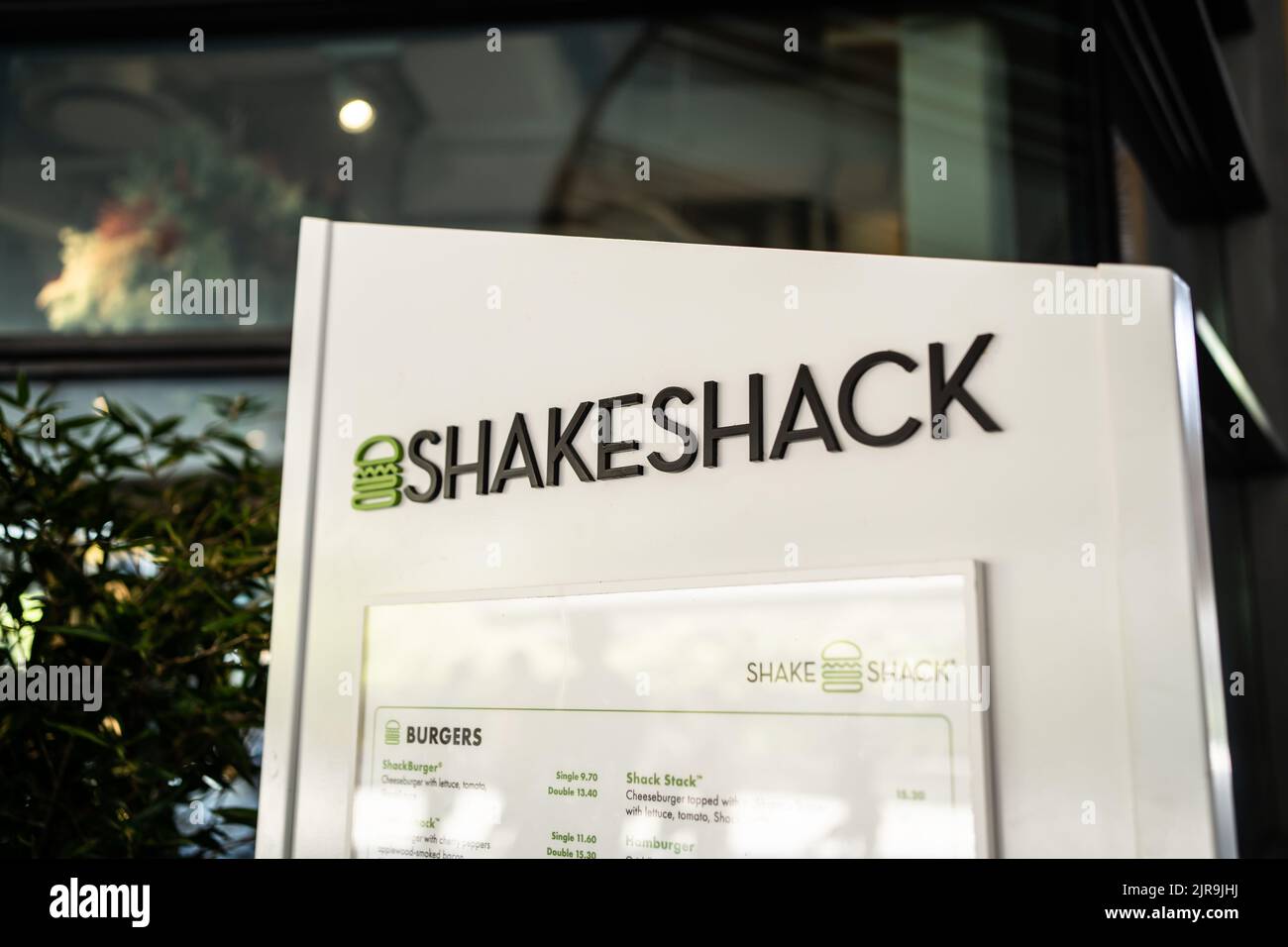 Singapore - July 21, 2022: Logo of Shake Shack, an American restaurant chain, in front of the restaurant. Stock Photo