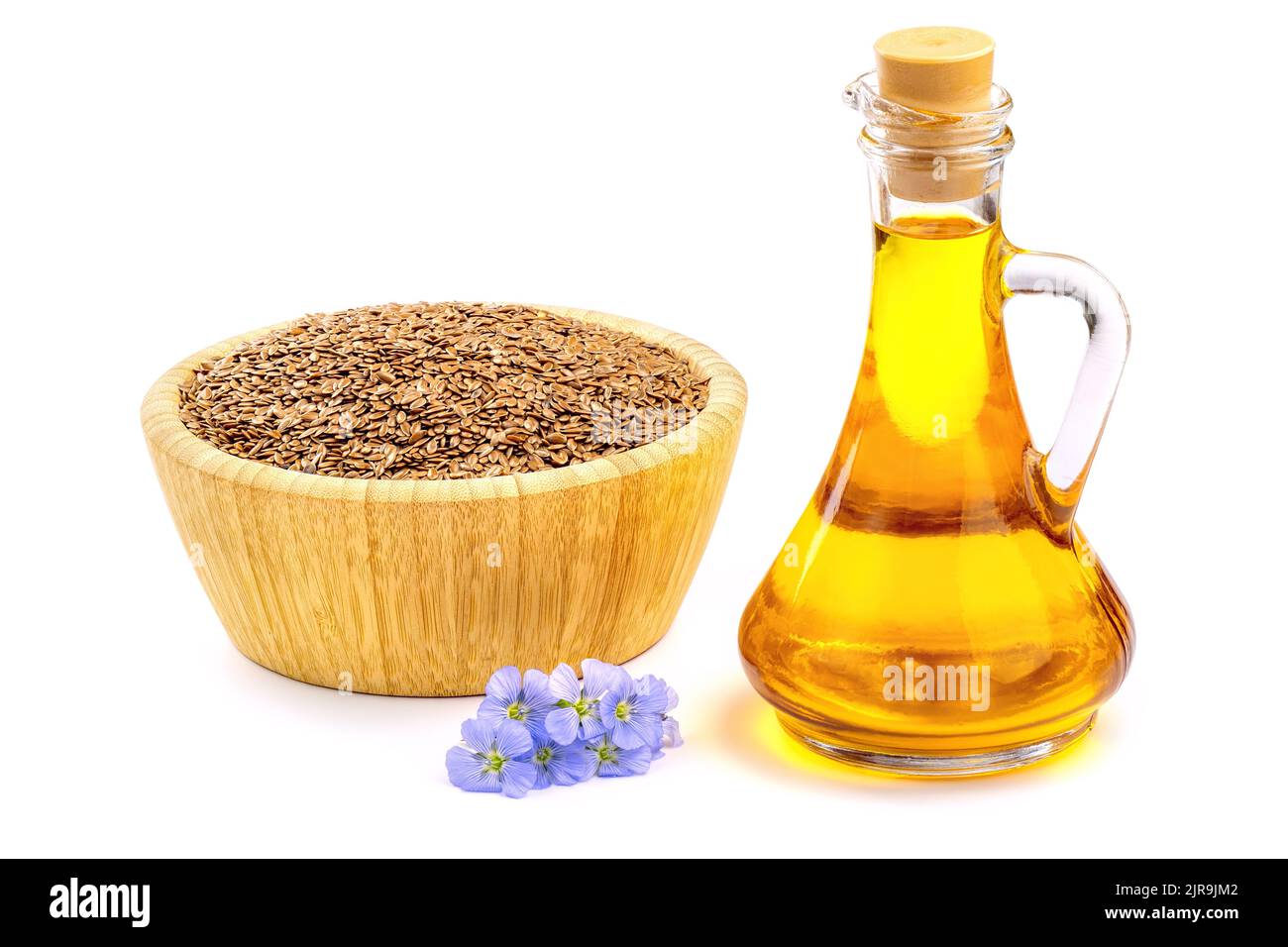 Blue flax flowers and raw flax seeds isolated on white background. Fresh pressed linseed oil is