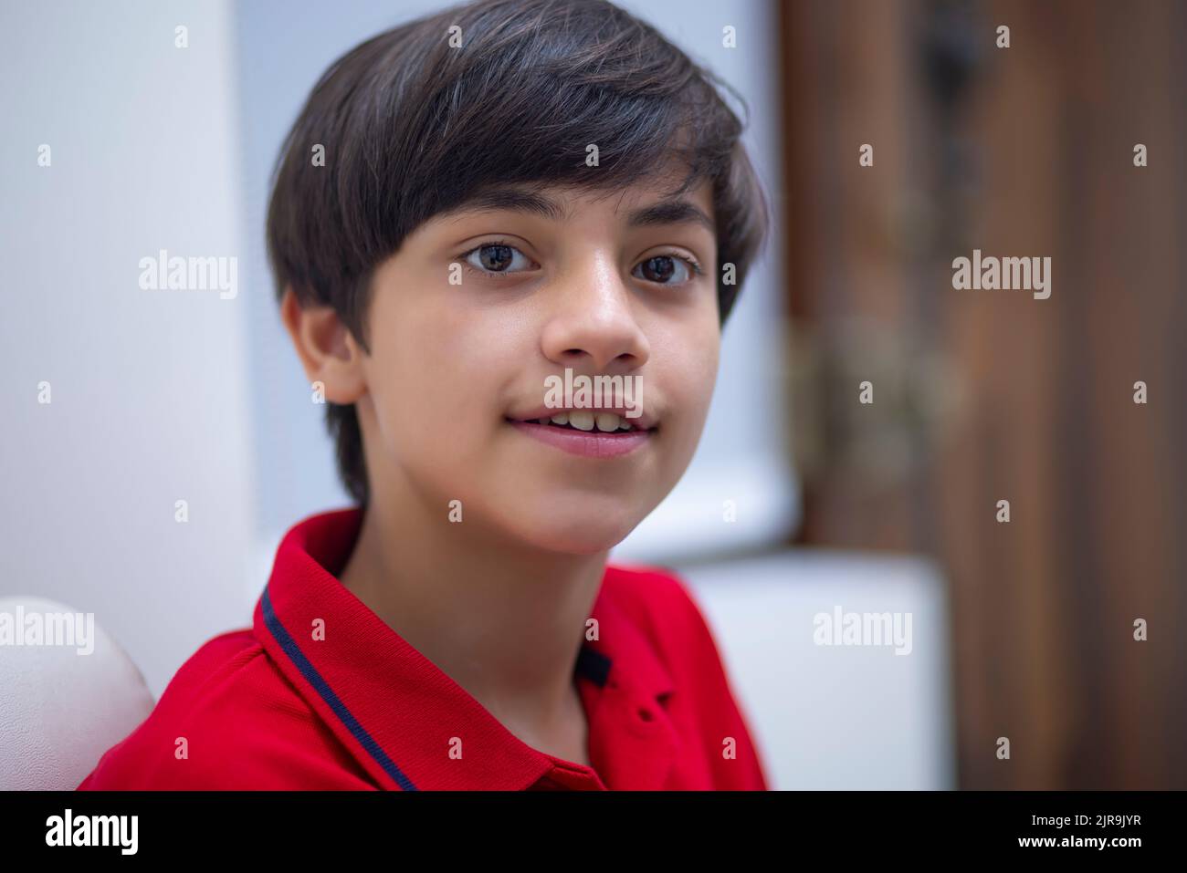 Close-up portrait of a young teenage boy looking at camera Stock Photo ...