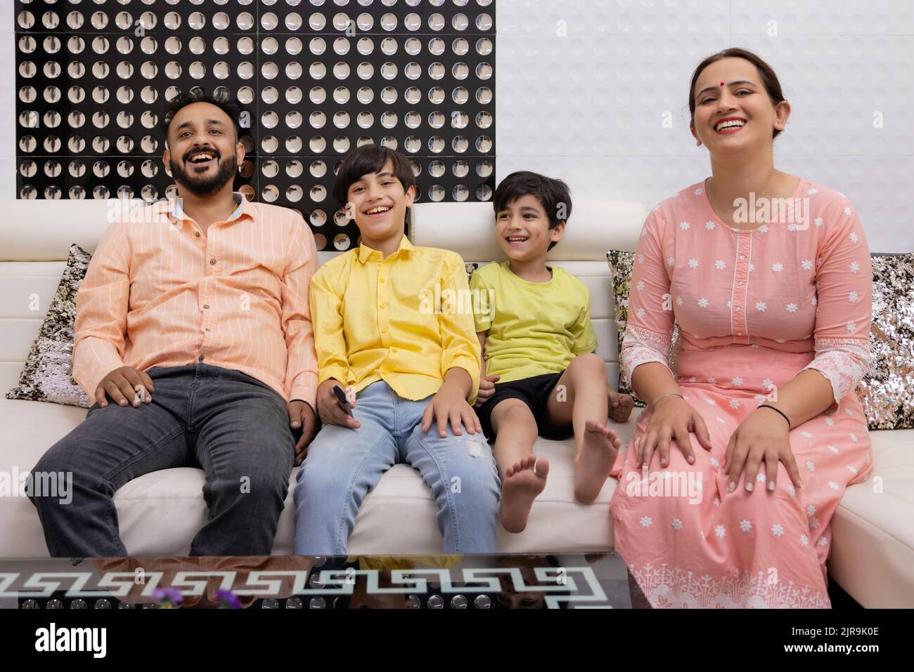 Happy family together watching TV at home Stock Photo