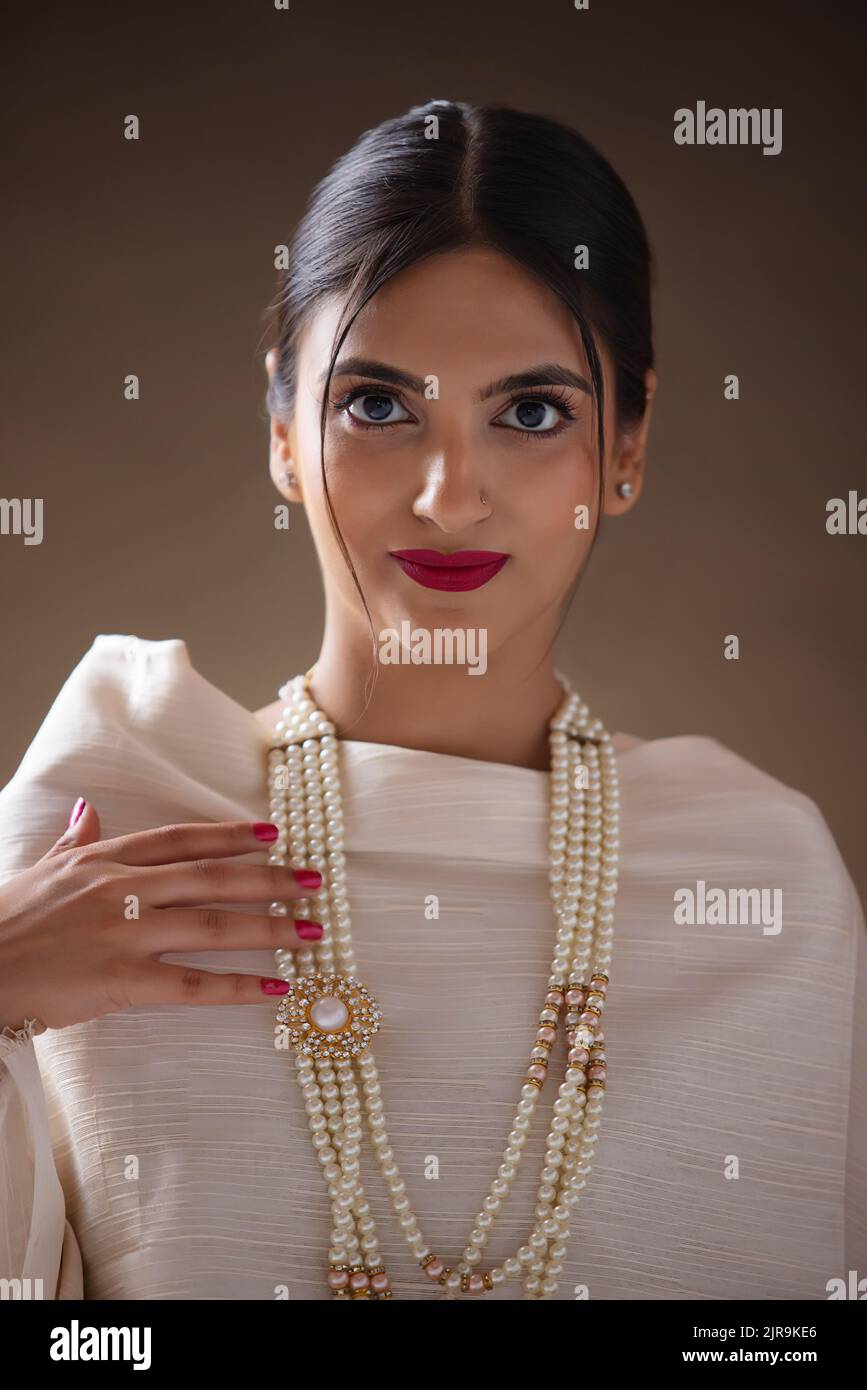 Portrait of a beautiful young woman wearing pearl necklace Stock Photo