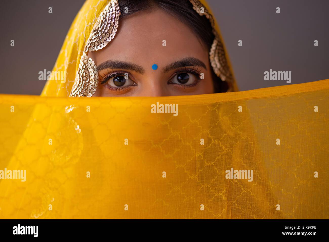 Portrait of an Indian woman in yellow veil Stock Photo