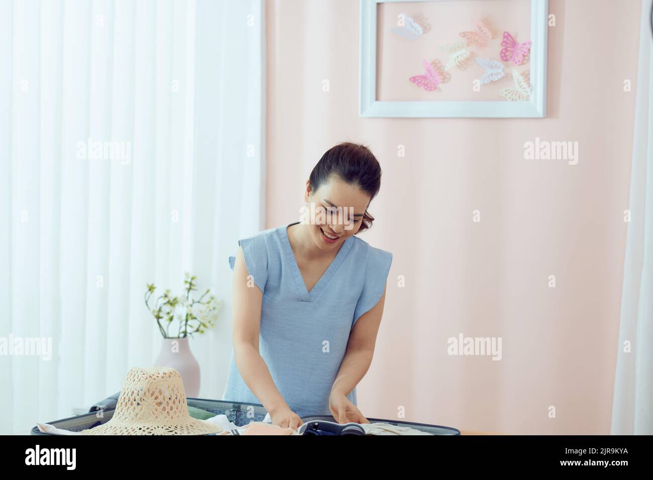 Woman packing suitcase home hi-res stock photography and images - Alamy